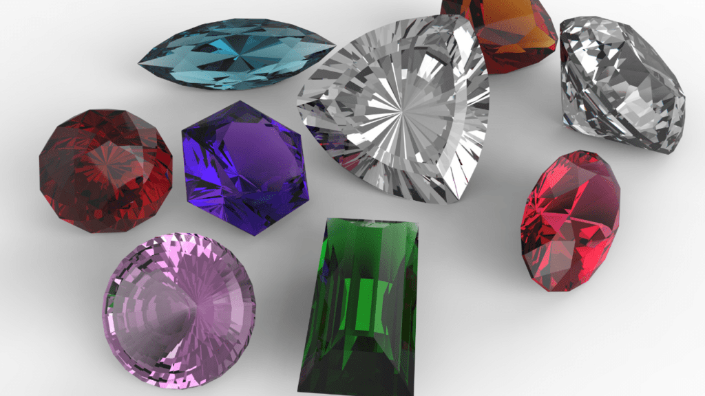 A stunning array of gemstones in vibrant colors—blue, green, purple, red, and clear—on a white surface, showcasing their unique cuts and brilliant facets.