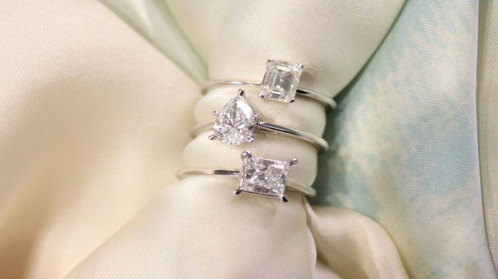 Diamond rings in emerald cut, pear cut, and princess cut.