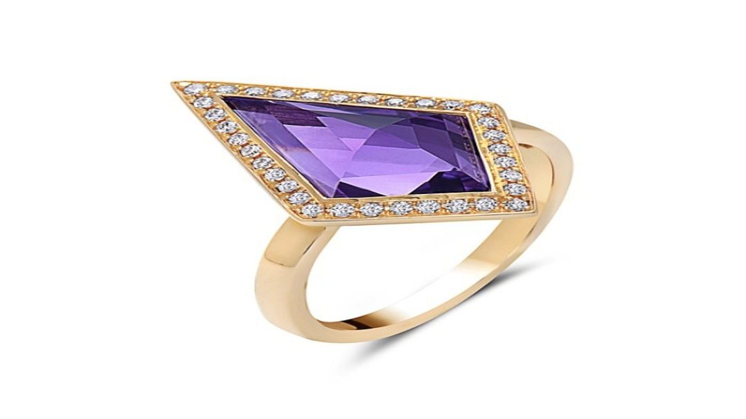 A striking gold ring featuring a large, kite-shaped purple gemstone surrounded by a border of small diamonds, showcasing a modern and elegant design.