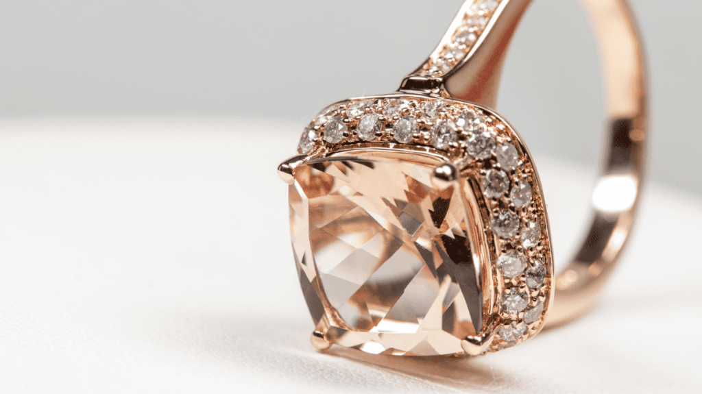 A radiant morganite engagement ring adorned with a halo of sparkling diamonds, set in a rose gold band, highlighting exquisite craftsmanship.