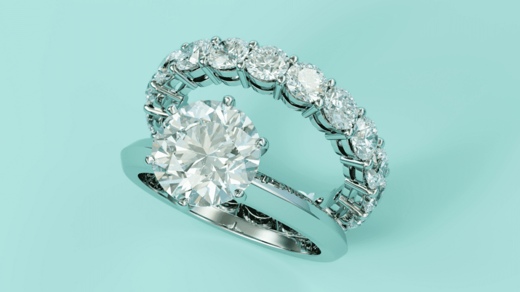 Delicate pearl-adorned gold rings hanging gracefully from a white orchid stem, showcasing elegance and natural beauty.
