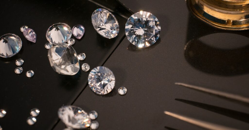 A close-up of a jeweler's workbench, featuring various gemstones and tools, showcasing the meticulous nature of jewelry repair. 