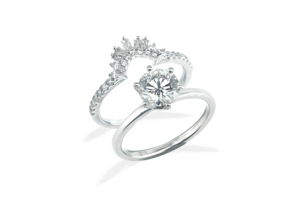 Elegant round diamond engagement ring paired with a unique V-shaped diamond band, showcasing exquisite craftsmanship and timeless design.