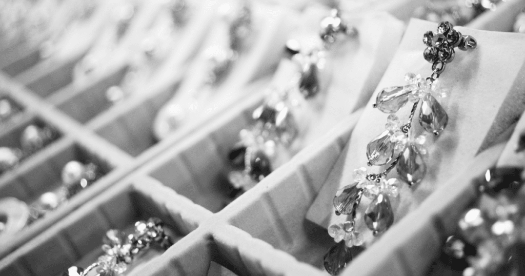 Close-up of sparkling crystal earrings displayed in a jewelry box, their intricate design catching the light in a soft, elegant ambiance.