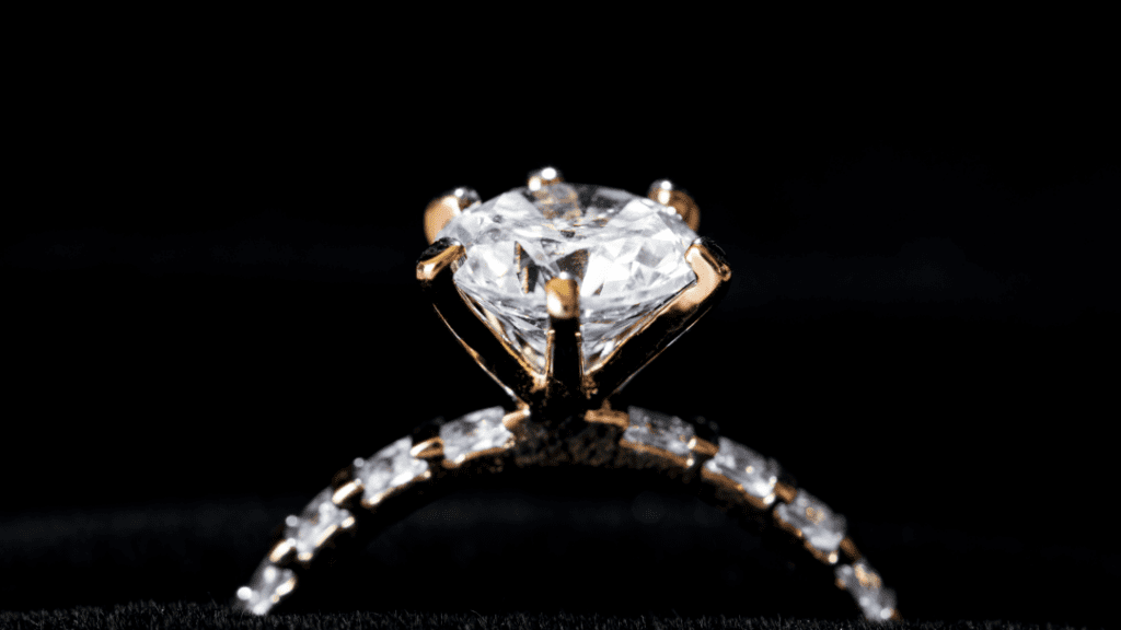 Dazzling diamond ring with a prong setting and a delicate band of smaller diamonds.