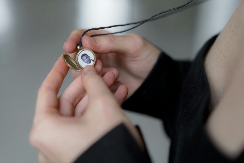 A nostalgic image of someone holding a locket with a cherished photograph.