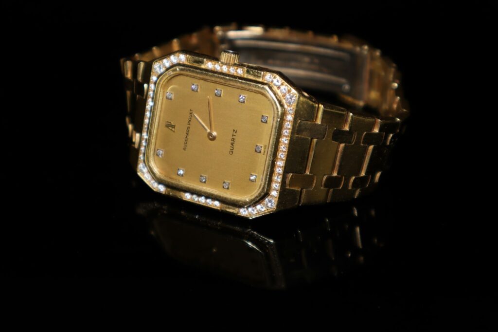 Gold Audemars Piguet watch with diamond-encrusted bezel and bracelet.