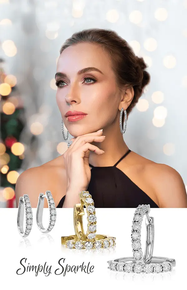 Woman elegantly wearing diamond hoop earrings, with a display of silver and gold diamond hoop earrings below, highlighted by a soft bokeh background.