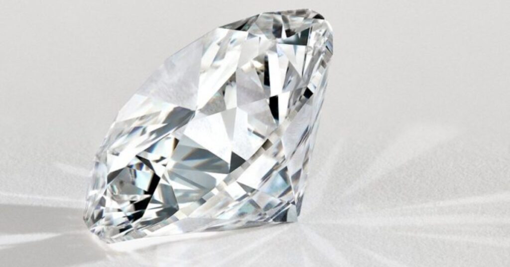 A sparkling, round diamond with a white background.