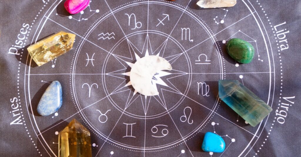  A close-up of crystals and zodiac signs, including a white crystal in the center.