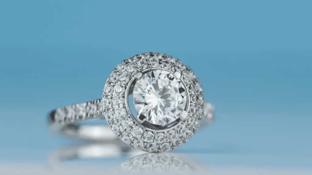 A stunning halo engagement ring featuring a round-cut diamond surrounded by smaller diamonds.