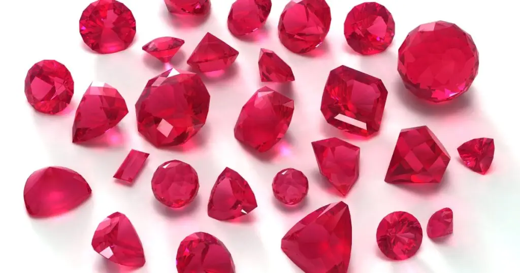 Multiple red garnet gemstones with a variety of cuts and sizes.