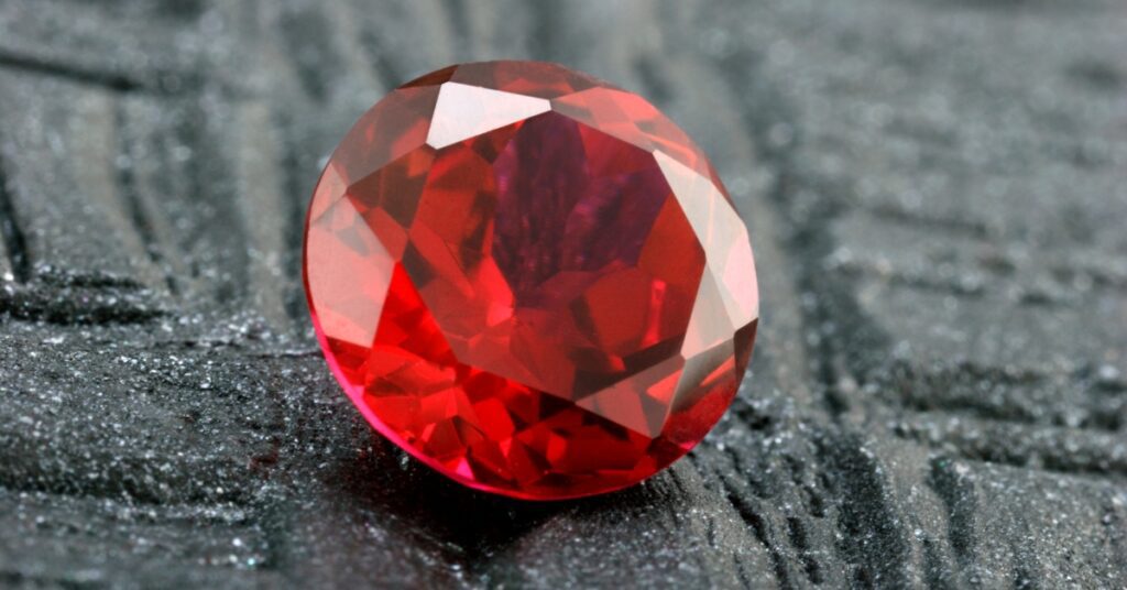 A precious ruby with a rich red hue and a translucent quality.