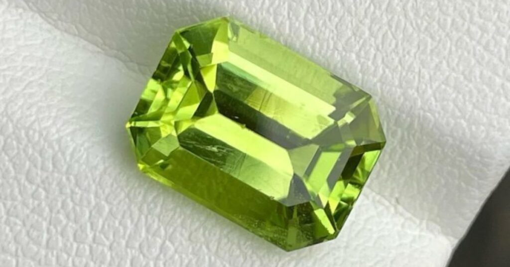 A rectangular peridot with a glossy finish and a deep green hue.