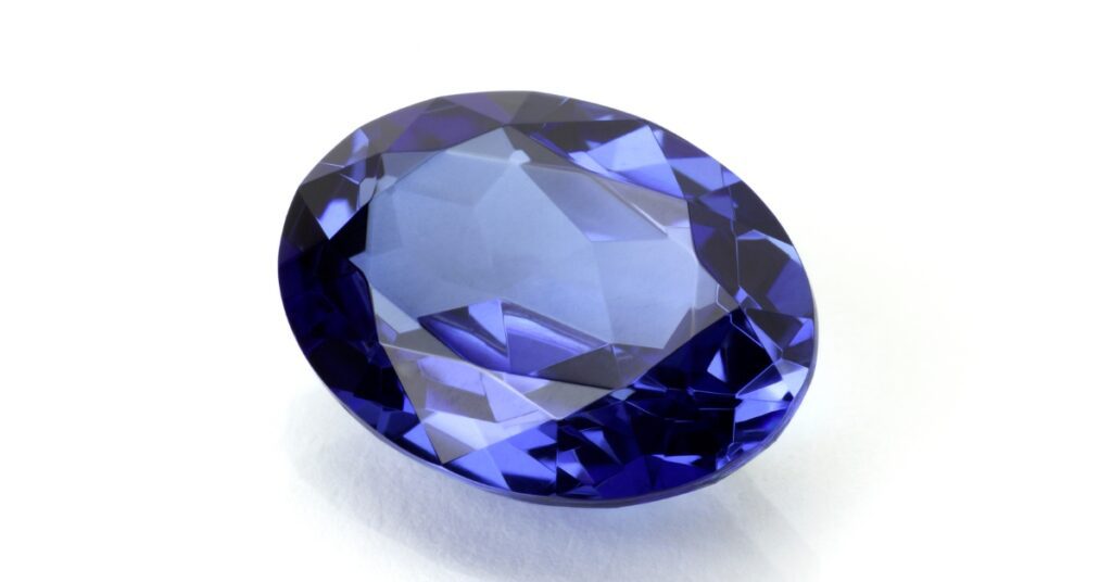 A vibrant blue sapphire gemstone with an oval cut.