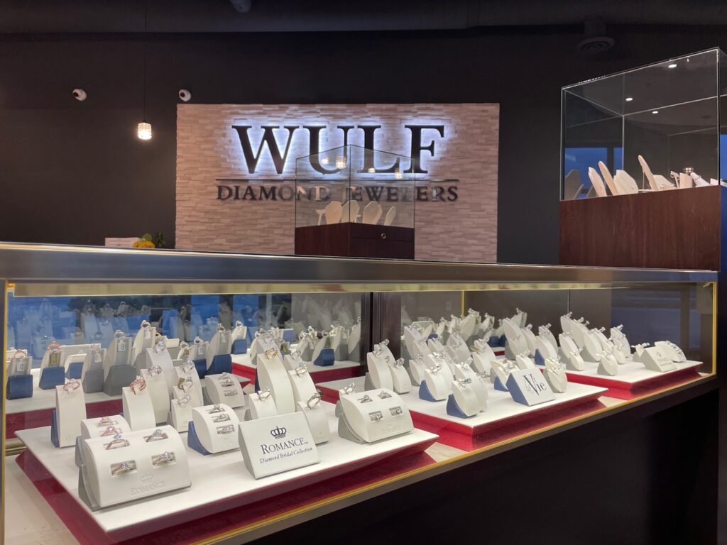 The interior of Wulf Diamond Jewelers, showcasing a modern and elegant design with display cases filled with jewelry.