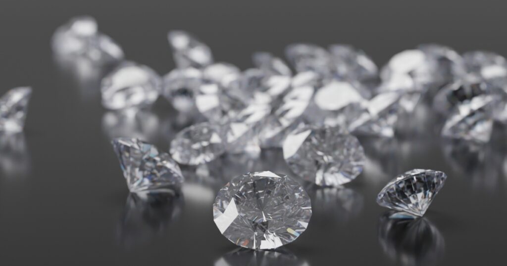 A cluster of sparkling diamonds on a dark surface.