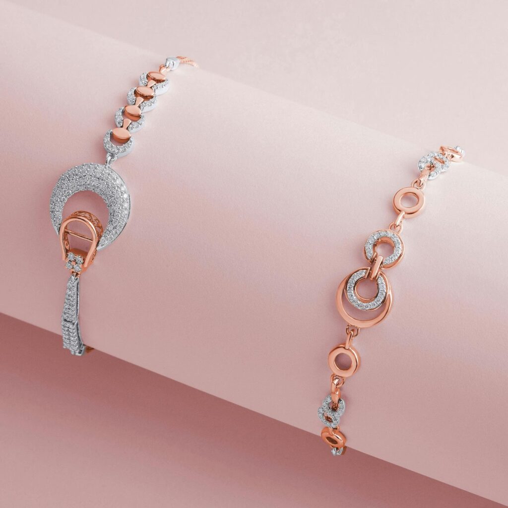 Two elegant bracelets with diamond accents on a pink background. One bracelet features a circular design with pave diamonds, while the other has a chain link design with diamond accents.