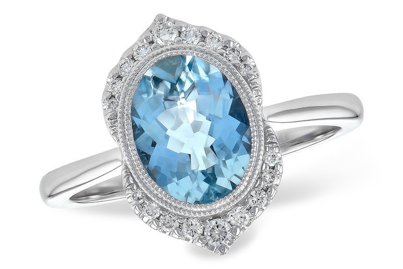 A beautiful ring with a large oval aquamarine stone surrounded by sparkling diamonds.