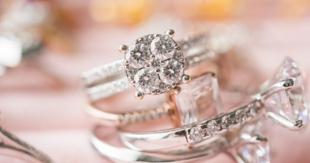 A close-up of multiple diamond rings, showcasing various styles and settings.