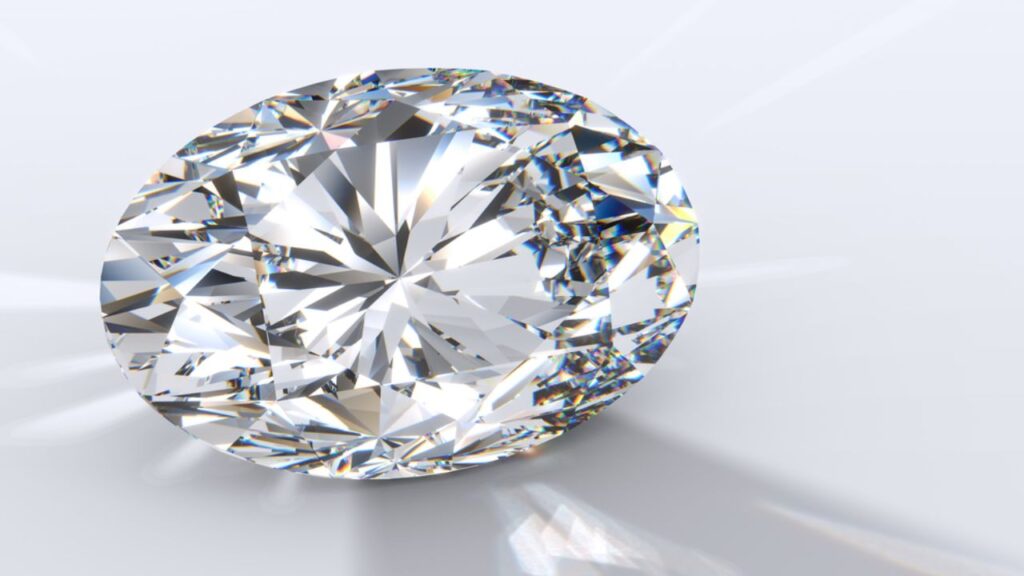 A radiant-cut diamond casting a colorful shadow on a white background.