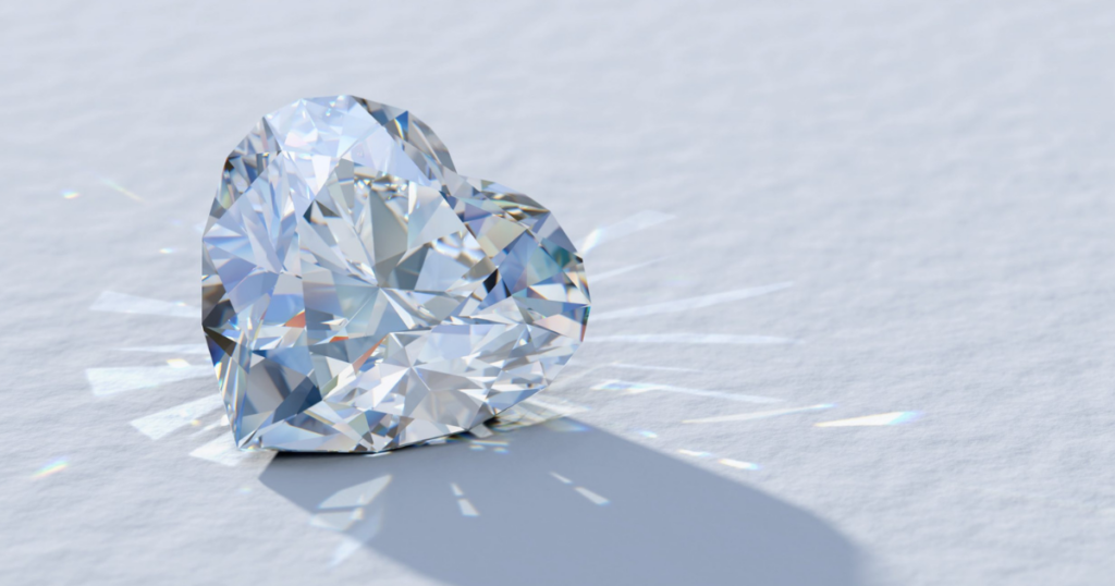 A sparkling heart-shaped diamond casting a radiant shadow on a white surface.