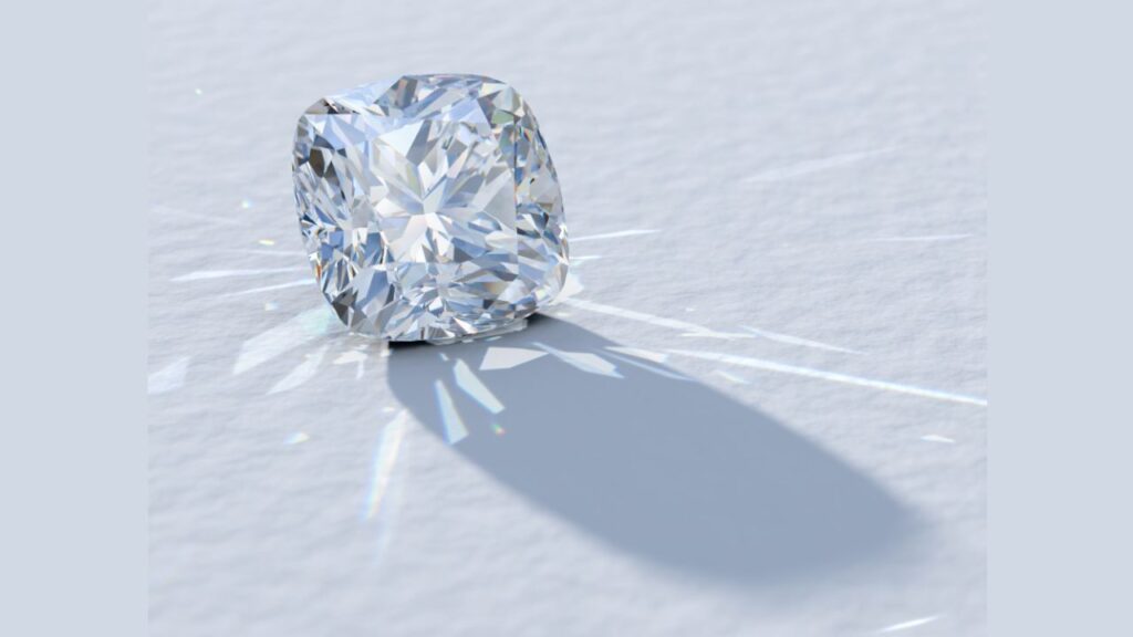 A radiant-cut diamond casting a colorful shadow on a white background.