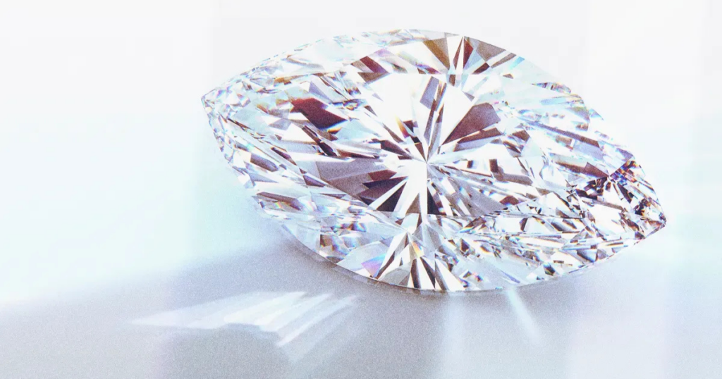 A sparkling marquise-cut diamond, casting a colorful shadow on a white background.