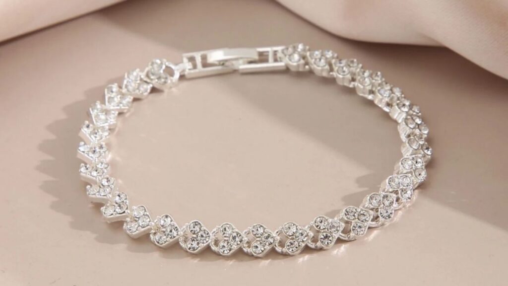 A delicate silver bracelet adorned with sparkling cubic zirconia stones, creating a dazzling and elegant look.