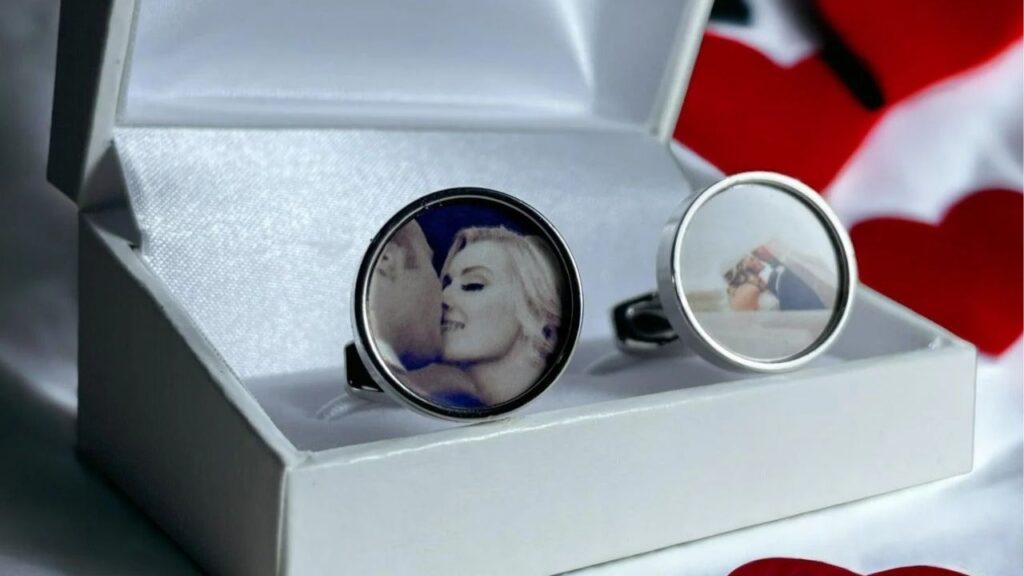 A sleek silver ring box featuring custom photo rings; a couple's intimate moment is displayed on one ring, adding a personal touch.