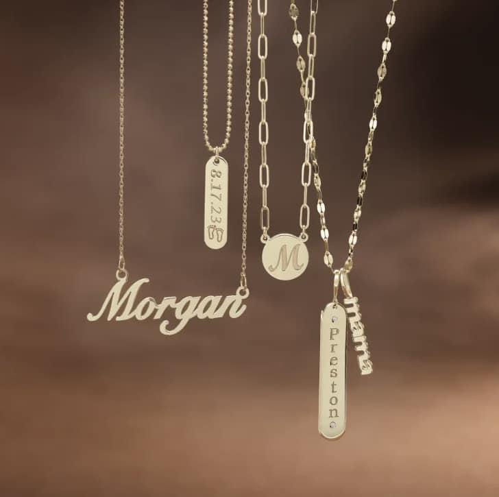 A beautiful array of gold necklaces featuring different styles and personalized engravings for a special touch.