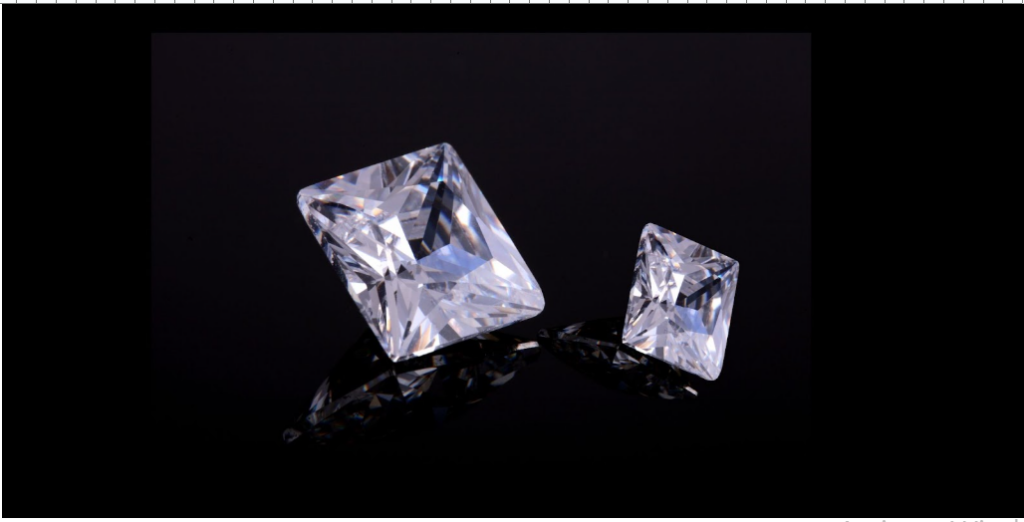 Two rectangular diamonds, one larger than the other, sparkling against a black background.