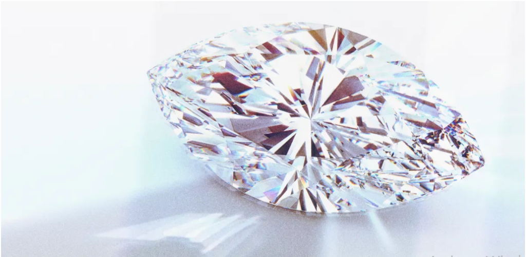 A sparkling marquise-cut diamond casting a colorful, refracted light shadow on a white surface.