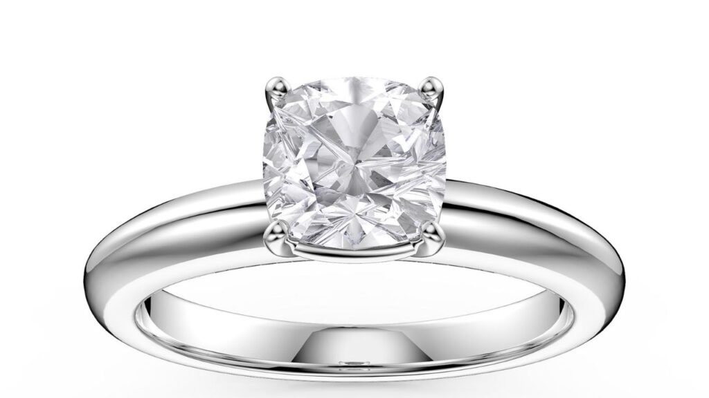 A classic solitaire engagement ring featuring a large, oval-cut diamond set in a simple, polished platinum band.