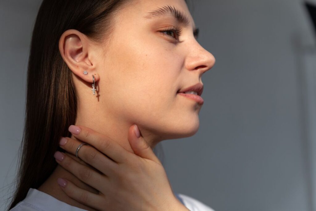 Woman with Jewelry And Watches: earrings and a ring, highlighted in a soft, natural light.