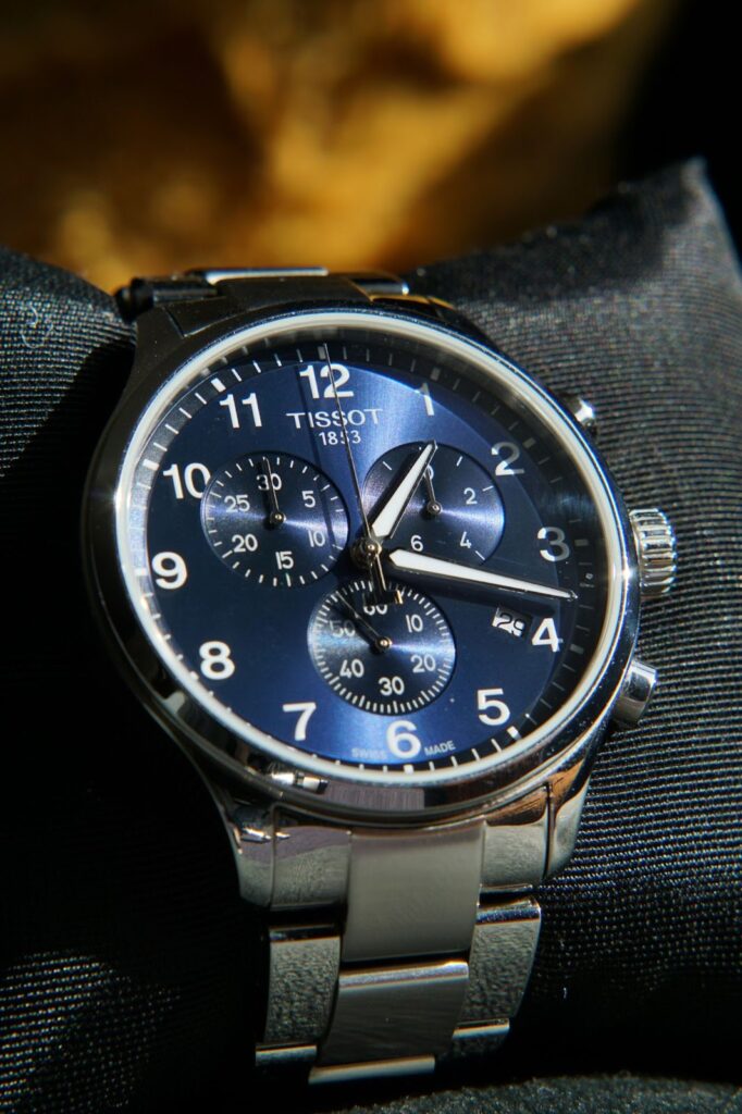 A close-up of a Tissot Chrono XL Classic watch with a blue dial, conveying Professional watches and impressions.