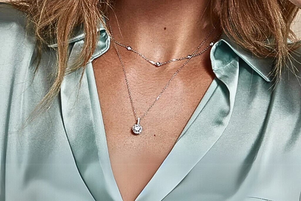 A hand with a delicate moon and star earring, highlighting Diamond Jewelry Essentials from Wulf Diamond Jewelers.