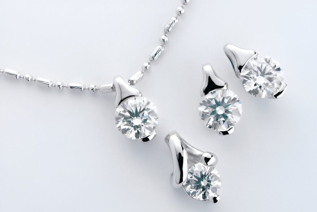 A sophisticated set of diamond necklace, earrings, and ring with halo settings, perfect Business Jewelry from Wulf Diamond Jewelers.