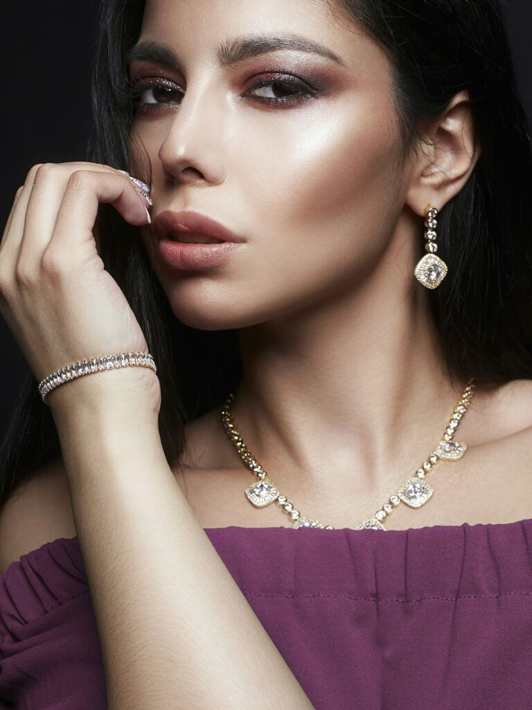 A young woman smiling, well-suited for a Work holiday party look from Wulf Diamond Jewelers.