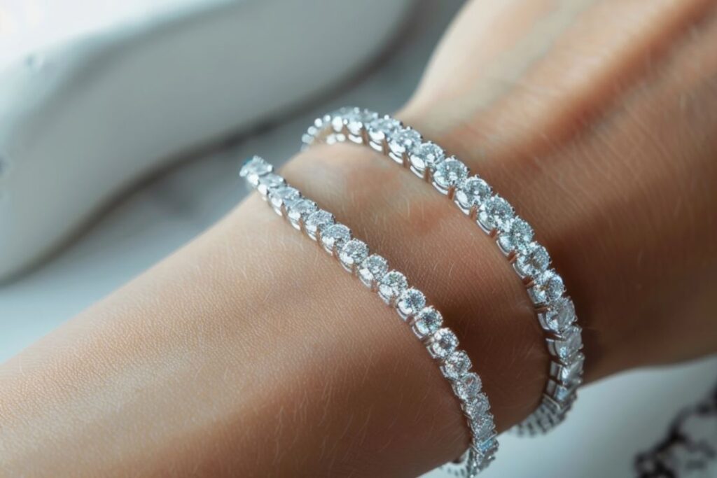 A hand displays two exquisite diamond bracelets, ideal for enhancing Business Jewelry from Wulf Diamond Jewelers.
