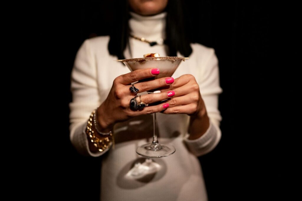 A model wearing exquisite gold and diamond jewelry, ideal for a Work holiday party, from Wulf Diamond Jewelers.