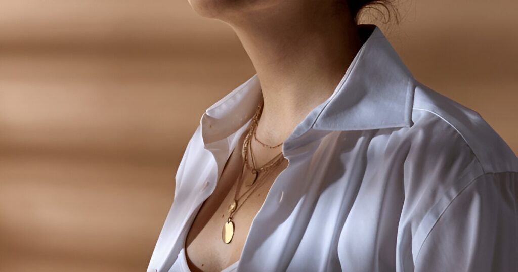 
The woman's layered gold necklaces and open white shirt show off the latest Tropical jewelry trends from Wulf Diamond Jewelers.