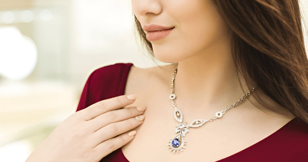 Woman wearing a blue gemstone necklace, Wulf Diamond Jewelers' elegant Cruise-friendly jewelry.