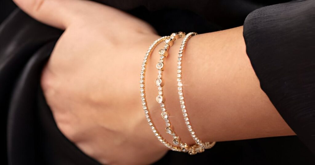 A person's hand adorned with a diamond bracelet, an exquisite piece from the resort jewelry collection by Wulf Diamond Jewelers.
